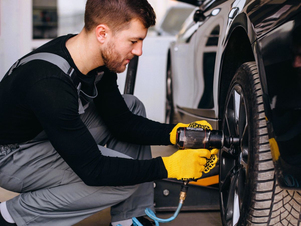 car-mechanic-changing-wheels-car